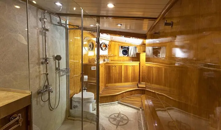 Master cabin with king bed, ensuite door, wood paneling, soft lighting