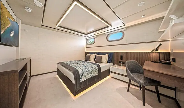 Master cabin with king bed, patterned bedding, and built-in ensuite area