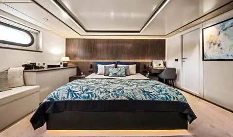 Anima Maris master cabin with king bed and ensuite, dark wood headboard
