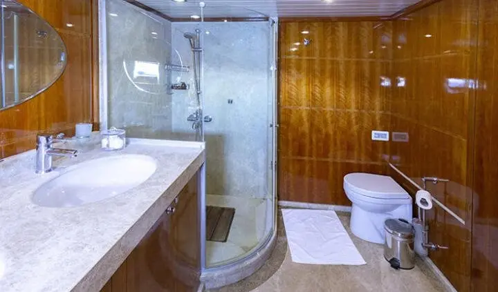 Master cabin on Silver Moon yacht with king bed, ensuite bathroom visible