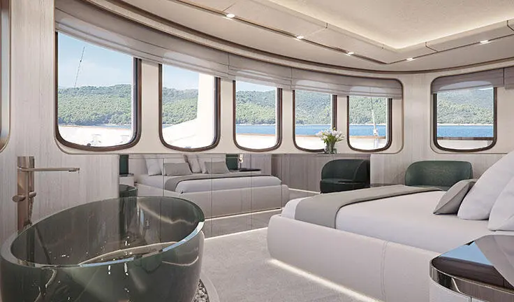 Maia yacht master cabin with king bed, white bedding, large windows, and seating area