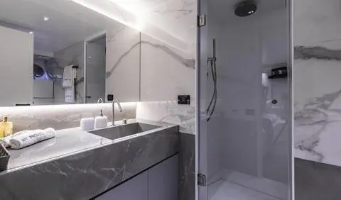 Master cabin with king bed, ensuite bathroom, modern fixtures, gray tones