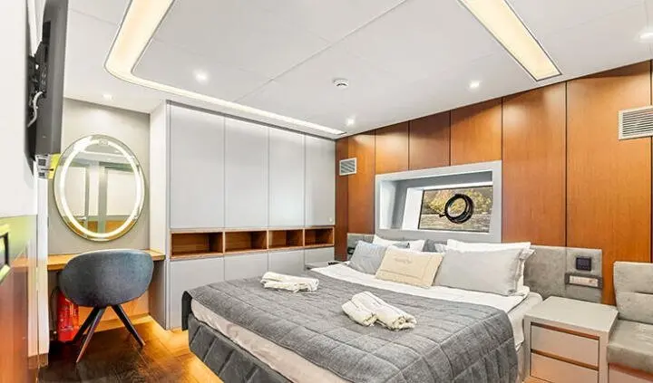 North Wind master cabin with king bed, ensuite, modern wood tones, soft lighting