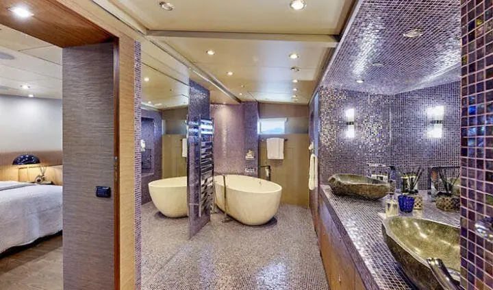 Luxurious yacht cabin with king bed, ensuite, and seating area, Daloli