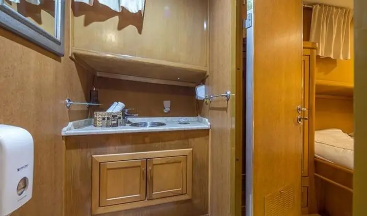 Morning Star yacht cabin with wooden vanity, sink, and mirror cabinet