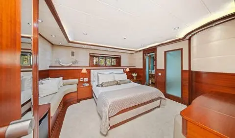 Master cabin with two single beds, wood paneling, built-in wardrobe, and ensuite area