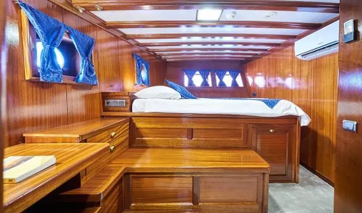 Stella Maris cabin interior with wood paneling, seating, and a skylight