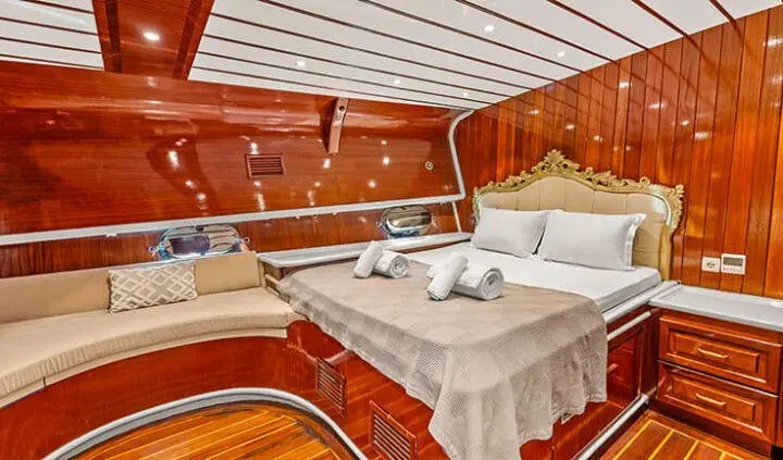 Esma Sultan master cabin with king bed, wood paneling, and ensuite setup