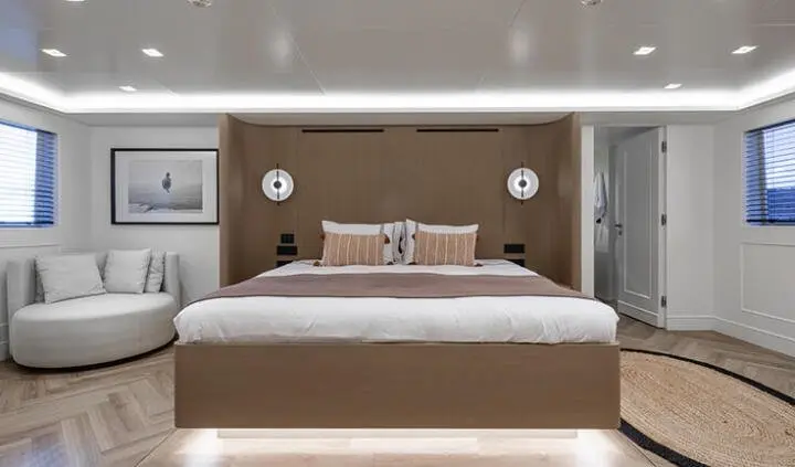 Illusion II master cabin with king bed, wood headboard, ambient lighting