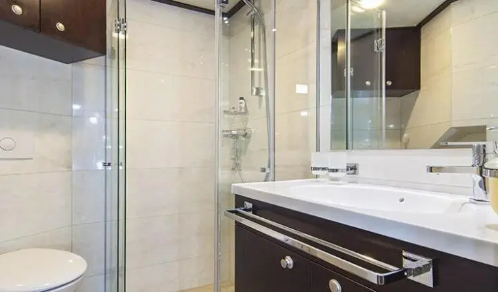 Navilux cabin suite exterior view showing glass door, beige walls, and bathroom vanity