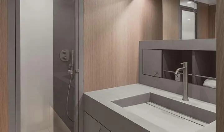 Nadamas yacht cabin interior with modern sink and shower area, neutral tones