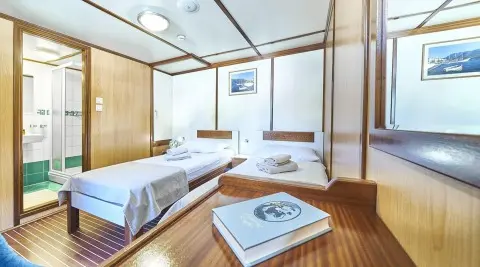 Luxurious Amorena yacht deck with sun loungers, polished wood, and seating area