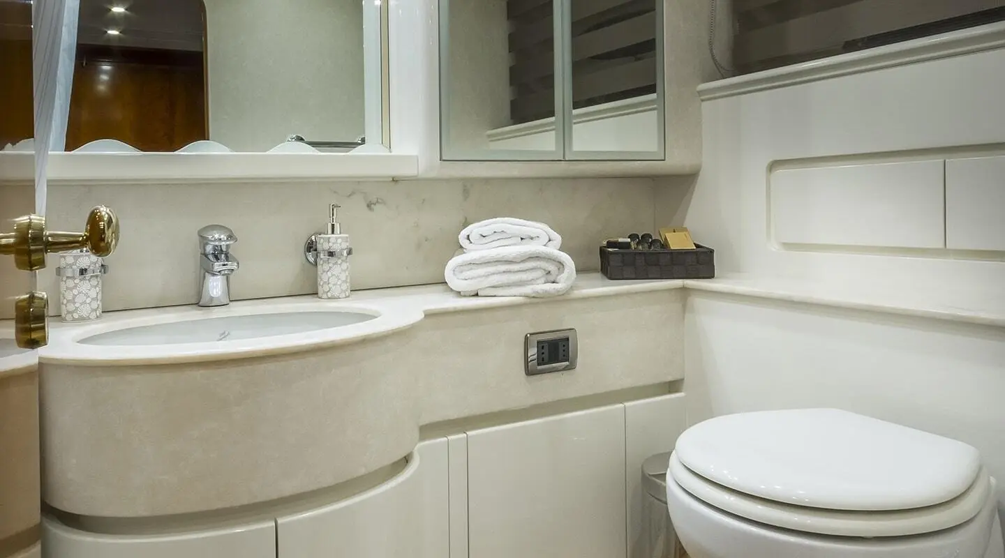 Interior of Amoraki yacht salon with curved beige cabinetry and sink area