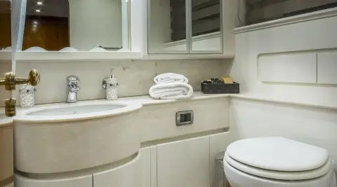Interior of Amoraki yacht salon with curved beige cabinetry and sink area