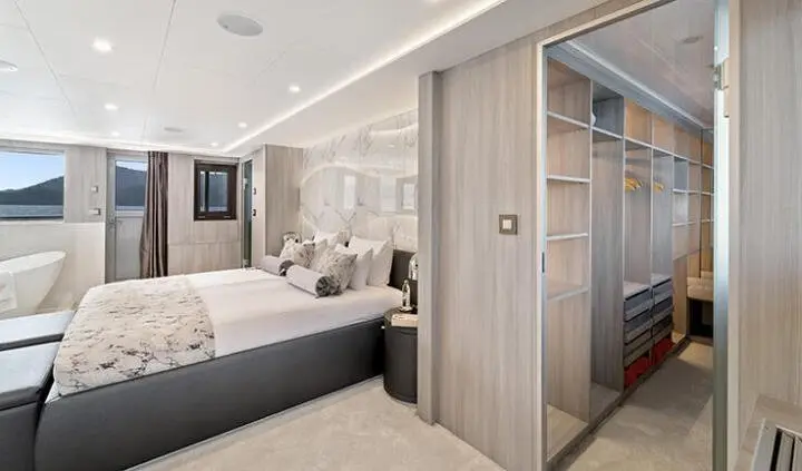 Luxurious master cabin with king bed, ensuite, neutral tones and soft lighting