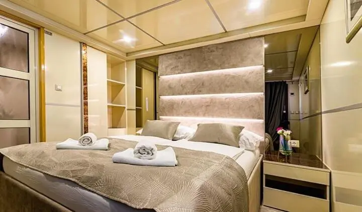 Master cabin on Melody yacht with king bed, ensuite, neutral tones
