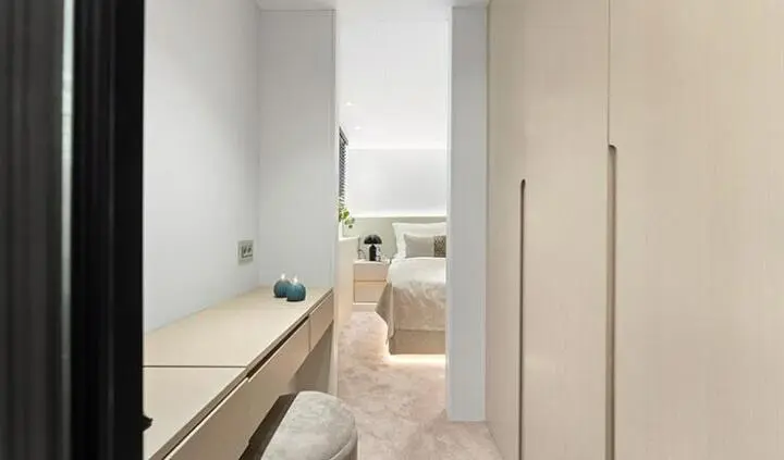 Master cabin with king bed, ensuite doorway, neutral tones, compact hallway