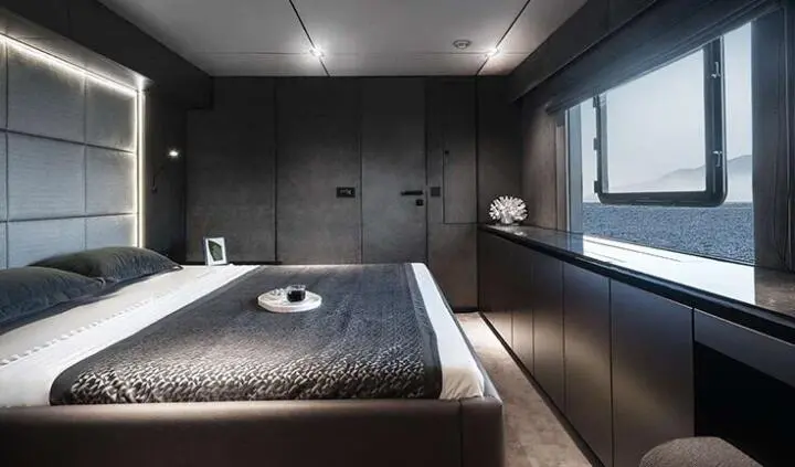 Alteya yacht cabin with dual bed setup, dark wood tones and windows