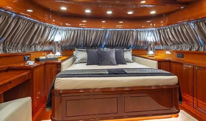 Divine yacht cabin with king bed, plush headboard, and en-suite visible