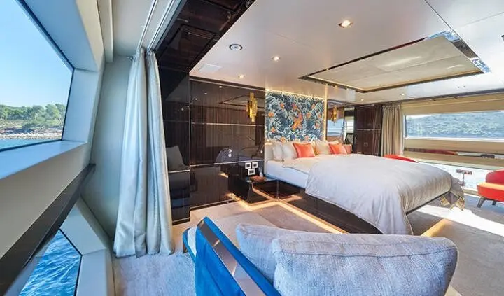 Master cabin with king bed, ensuite visible, blue accents, window view