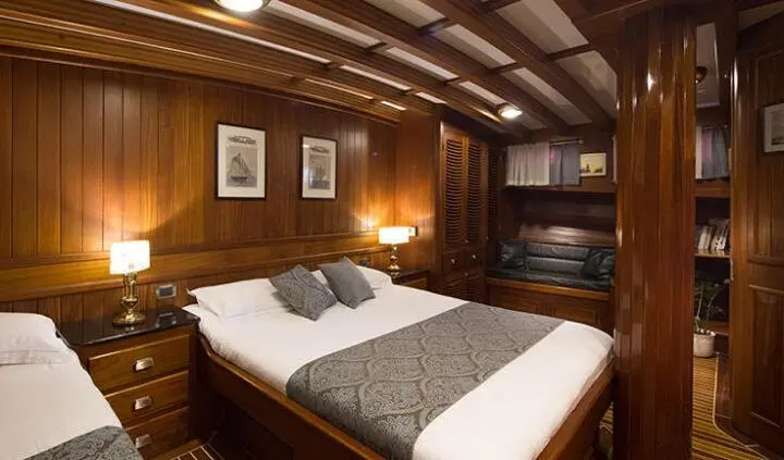 Carpe Diem 7 cabin with two beds, wood paneling, and soft lighting