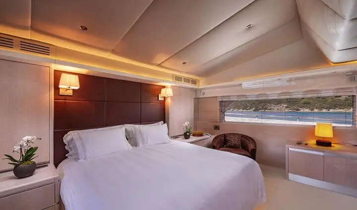 Magix yacht master cabin with king bed, neatly made, ensuite area visible