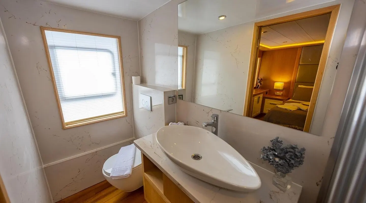 Interior of luxury yacht Simay M with a double sink vanity and bright windows
