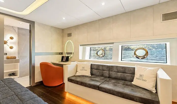 North Wind yacht cabin with king bed, ensuite, neutral decor and seating