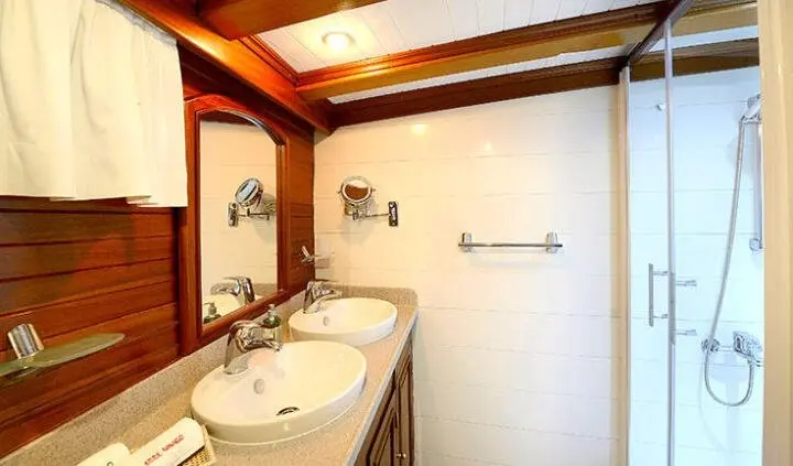 Ecce Navigo master cabin with king bed and ensuite bathroom visible