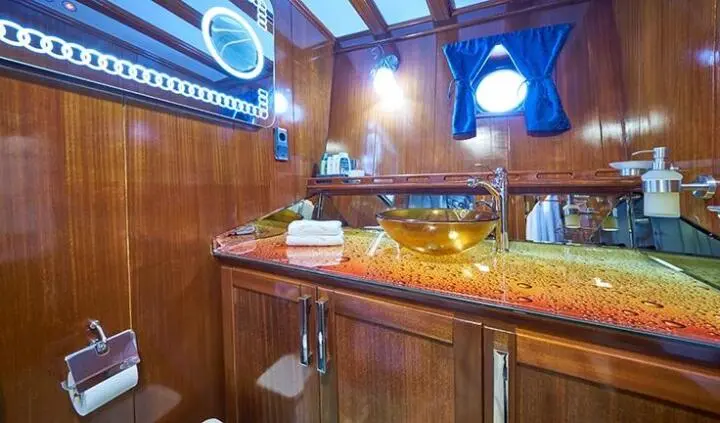 Stella Maris cabin interior with wooden cabinetry and blue accent lighting