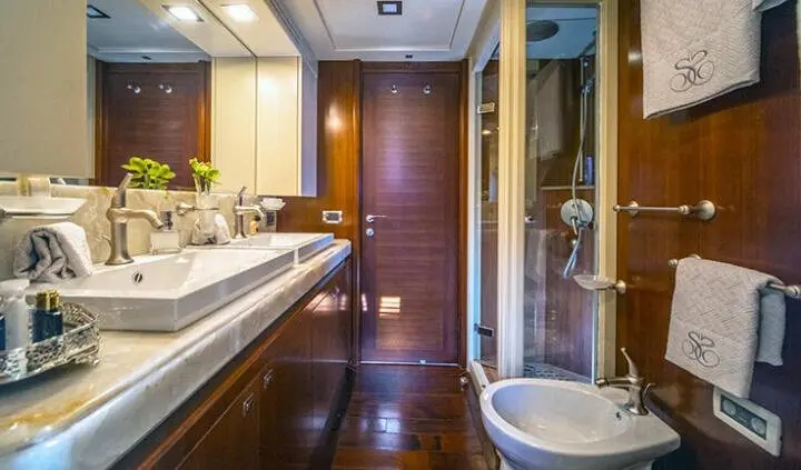 Master cabin with king bed, ensuite bathroom, wood paneling, neutral lighting