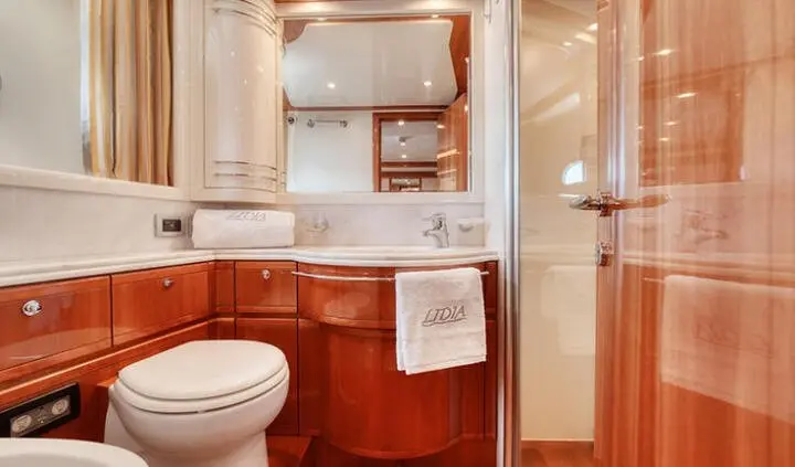 Master cabin with king bed, ensuite bathroom, wood cabineting, white bedding