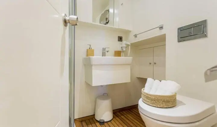 Master cabin with king bed, ensuite, sea view window, wood floor and white fixtures