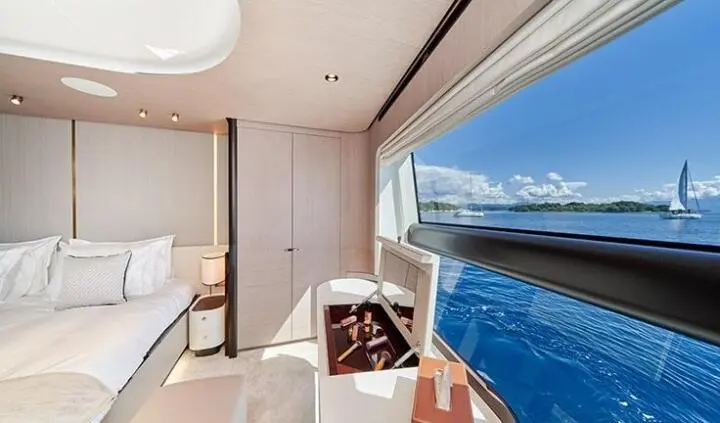 Master cabin with king bed and ensuite on Aluminia Too yacht, view through window