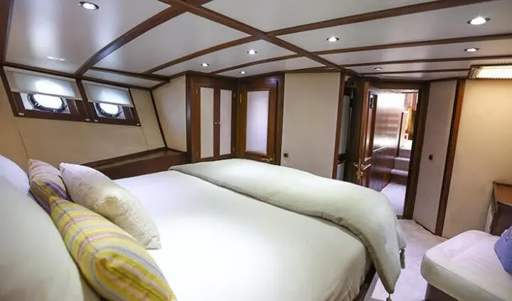 Gazella yacht cabin with two twin beds and wood paneling