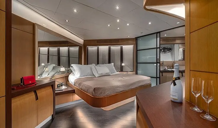 Master cabin with king bed and ensuite on yacht, luxurious wood panels