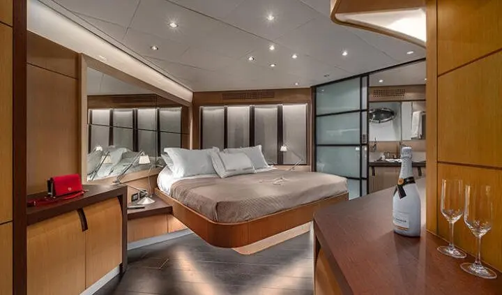 Master cabin with king bed and ensuite on yacht, luxurious wood panels
