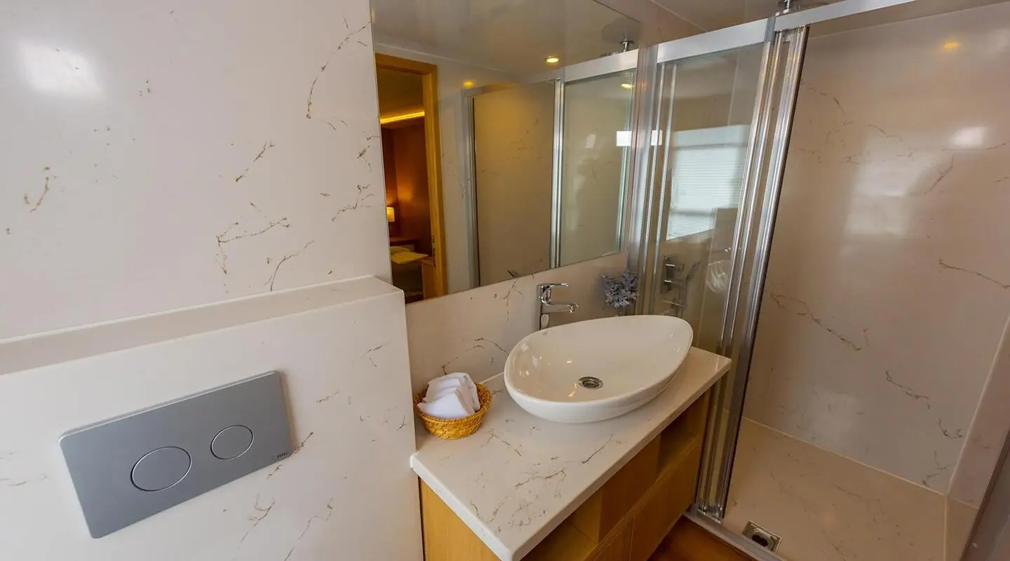 Interior of luxury Simay M yacht suite with wooden vanity, sink, and large mirror