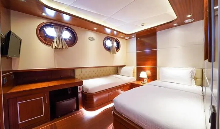 La Bella Vita yacht cabin with twin beds, ensuite area visible
