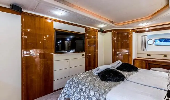 Miss Katariina cabin with a bed, built-in storage, and flat-screen TV on wood panel wall