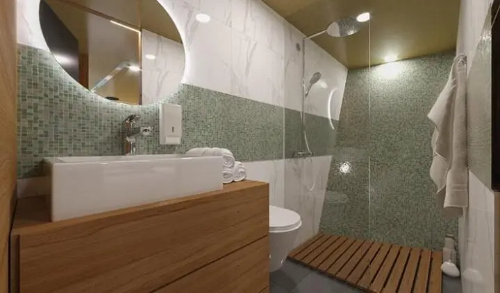 Luxurious yacht bathroom with wooden vanity, glass shower, and green tiled walls