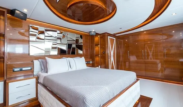 Master cabin with king bed, ensuite, wood cabinetry and porthole view