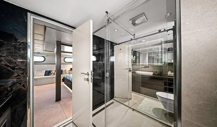 Anima Maris cabin interior with glass shower, modern ensuite, and plush seating visible