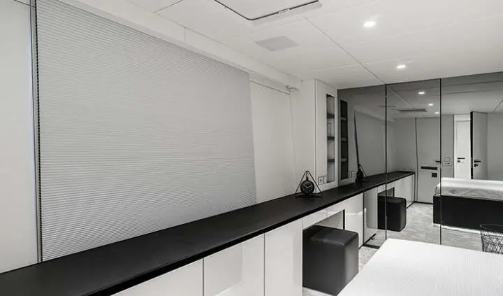Master cabin with king bed, ensuite, white walls, dark cabinetry, window shades