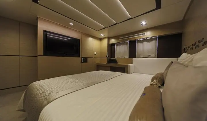 Master cabin with king bed, ensuite, neutral tones, overhead lighting