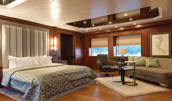 Ocean Breeze master cabin with king bed, ensuite, wood tones, seating area
