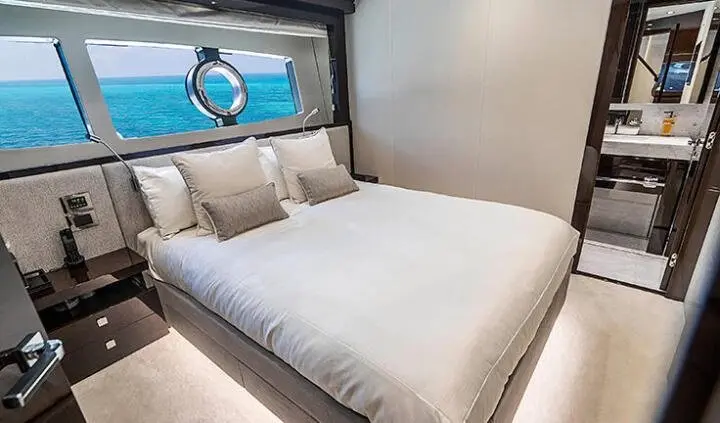 Quantum yacht master cabin with king bed, white linens, and ensuite visible