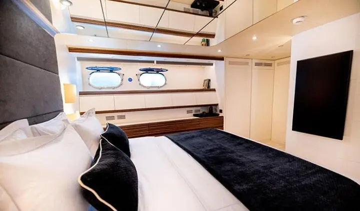 Pareaki II master cabin with king bed, ensuite, wood accents, porthole windows
