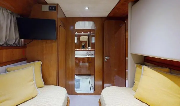 Twin cabin aboard Lady Natassa: two single beds with yellow pillows