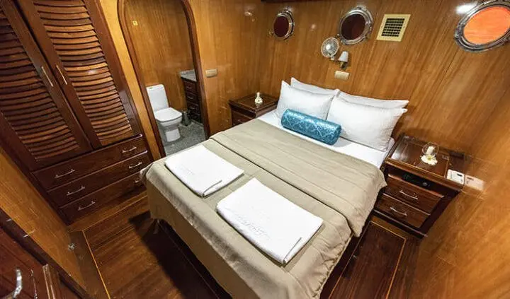 Kayhan 8 master cabin with king bed, white linens, wood paneling, ensuite likely